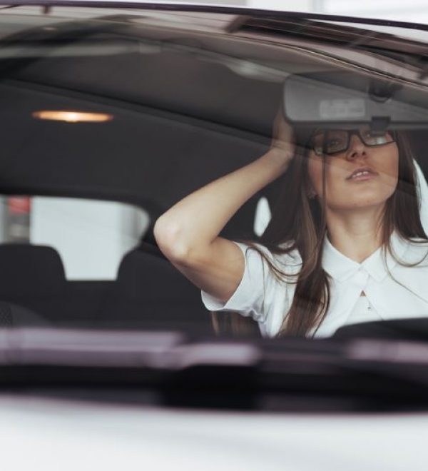 driver checking center mirror after accident
